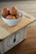 Brown eggs in bowl on weight scale