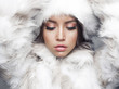 Beautiful woman in white fur coat and fur hat