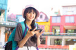 © Bavorndej - Portrait of Happy Traveler Woman in city. Asian women Using Smartphone for seach Location. Woman with Travel Concept.