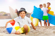 © Sergey Novikov - Many kids on beach and boy with inflatable ball