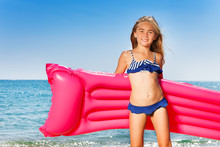 Young Girl In Bikini With Pink Inflatable Mattress