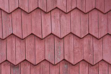  Painted red wooden boards laid in a herringbone ornament frieze as background, texture