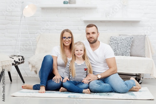 Plakat Szczęśliwa rodzina siedzi na podłoga w domu
