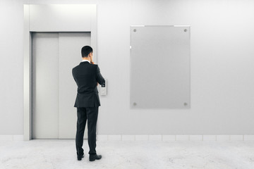 Wall Mural - businessman with poster and elevator