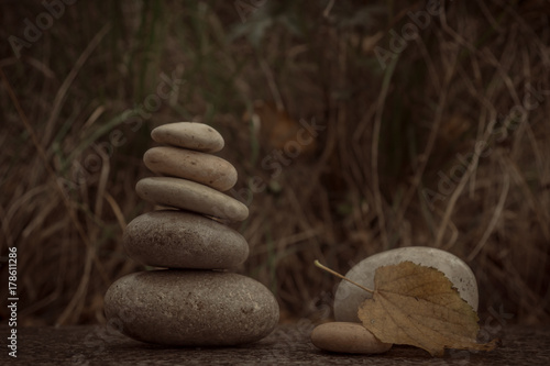 Plakat Zen kamienie na granitowej powierzchni na jesieni tle. Pojęcie pokoju i równowagi.