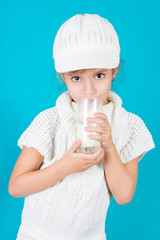 Beautiful little girl with glass of milk