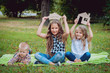 © romaset - Little girls with advertising signs in the park. Summertime