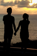 silhouette of a couple in love looking the sunset