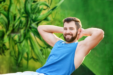 Wall Mural - Handsome young man exercising outdoors