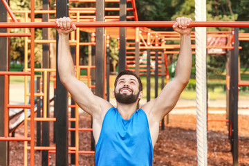 Wall Mural - Handsome young man exercising in park