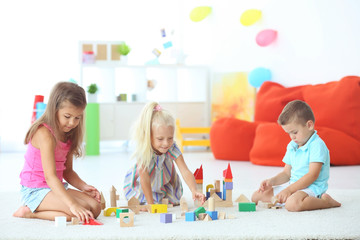 Canvas Print - Cute children playing with blocks indoor