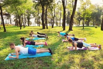 Wall Mural - Group of young people training in park