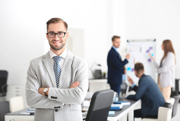 Wall Mural - Young handsome man in office