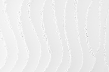  White abstract soft smooth crumbly plaster background with vertical curved waves.