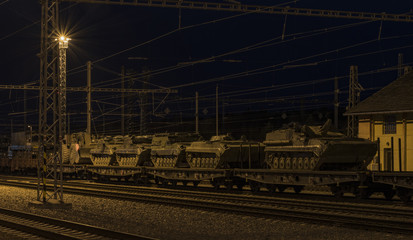 Train with army tanks in autumn night in Veseli nad Luznici