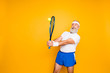 © deagreez - Competetive emotional cool grandpa with humor grimace exercising holding equipment, swatting ball with strength and power. Body care, hobby, weight loss, lifestyle, game process