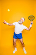 © deagreez - Competetive emotional cool grandpa with humor grimace exercising holding equipment, swatting ball with strength and power. Body care, hobby, weight loss, game process
