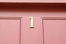 House Number 1 Sign On Red Painted Door