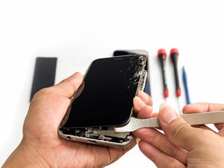 Wall Mural - Close-up of technician hand taking off cracked smartphone screen on blurred smartphone component background