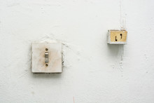 Close Up Old White Light Switch On Wall