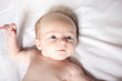 © Louis-Paul Photo - Peaceful baby lying on a bed on parent room