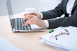 © rogerphoto - Close-up of business woman  hands  typing on  laptop computer in the white colored office.