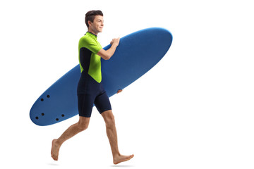 Sticker - Teenage surfer with a surfboard running