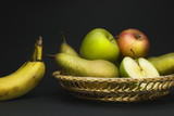 Fototapeta Kuchnia - Still life with fruit basket, pears, apples and bananas isolated on gray