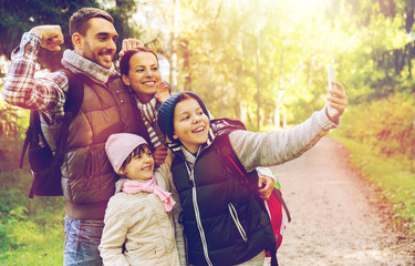 Poster - family with backpacks taking selfie by smartphone