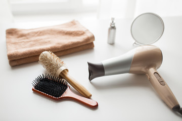 hairdryer, hair brushes, mirror and towel