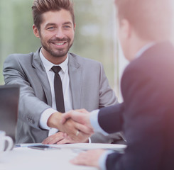 Business handshake. Two business people shaking hands in office.