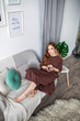 © Yuliya - Happy Teen Girl Resting on Sofa at the Living Room While Reading her Favorite Novel Book