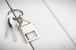 © Prostock-studio - Bunch of keys with house shaped keychain on white wood