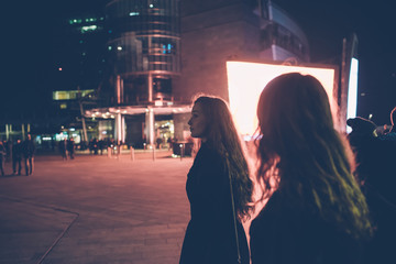 two young women friends walking outdoor night having fun - happiness, girl power, interaction concept