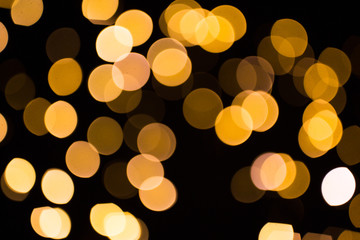 Wall Mural - blurred golden lights over dark background
