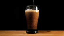 A Pint Of Dark Ale Beer Or Stout Is Poured Up.