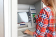 © Africa Studio - Woman inserting credit card into cash machine