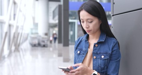 Wall Mural - Woman use of mobile phone in airport