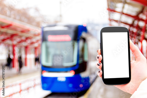 Download Female Woman Girl Hand With Mockup Smartphone Mobile Phone With Blue Tram And Public Transport Station On Background In Winter Stock Photo Adobe Stock