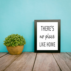 Wall Mural - Motivational and inspirational life quotes - There's no place like home. Frame and plant with teal blue background, retro style.