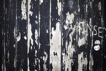 Vandalised, Cracked And Peeling Paint On Boarded Up Wood Windows Creates A Grunge Texture Background