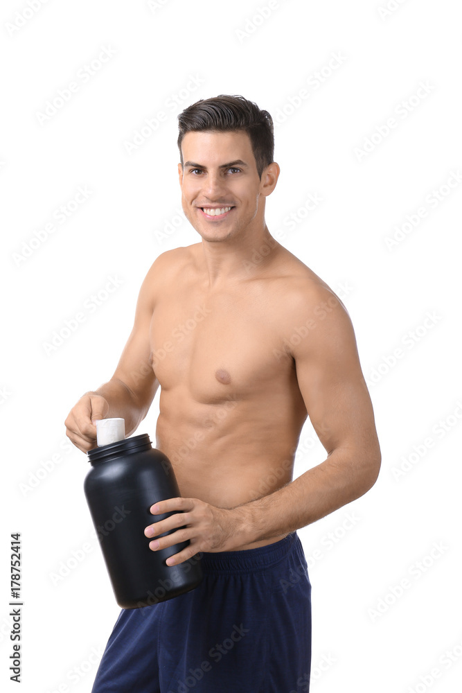 Shirtless young man holding black jar with protein powder on white background