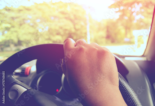 close-up-of-hand-driving-car-for-parking-a-holiday-trip-with-soft-light-morning