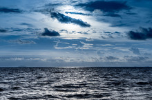 Blue Dark Dramatic Sky With Shining Ocean