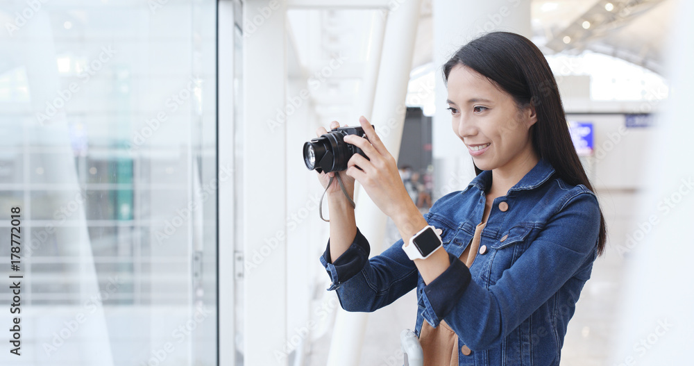 Woman taking photo in Hong Kong airport Stock Photo | Adobe Stock