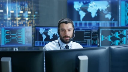 Poster - In the System Monitoring Room Dispatcher Speaks into Headset, Observers Proper Functioning of the Facility. He's Surrounded by Screen Showing Technical Data. 