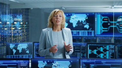 Leinwandbilder - In the System Control Room Female Chief Engineer Describes Her Project Talking into the Camera. In the Background Multiple Screens Showing Interactive Data. Shot on RED EPIC-W 8K Helium Cinema Camera.