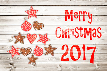 Wall Mural - Christmas greeting card 2017, rustic ornaments on wood planks background creating the shape of a Christmas tree