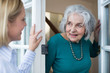 Woman Checking On Elderly Female Neighbor