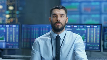 Poster - Stock Market Top Trader Thinking Hard on Selling Stocks at the Best Time. Behind Him People Working and Monitors Show Graphs and Ticker Figures. Shot on RED EPIC-W 8K Helium Cinema Camera.